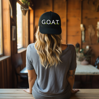Step into greatness with our G.O.A.T. (Greatest Of All Time) Trucker Hat. This comfortable and unisex cap is more than an accessory; it's a statement. 