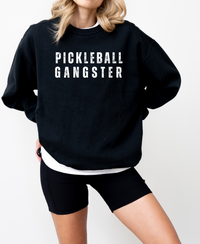 Unleash your inner pickleball boss with our Pickleball Gangster Sweatshirt! It's more than just a sweatshirt, it's a statement. Whether you're dominating on the court or off, this sweatshirt will show just how passionate and unstoppable you are. Wear with leggings, a skort/skirt, shorts or jeans. Either way you'll look amazing and love how you feel! Join the pickleball gang today and let this sweatshirt speak for itself! 