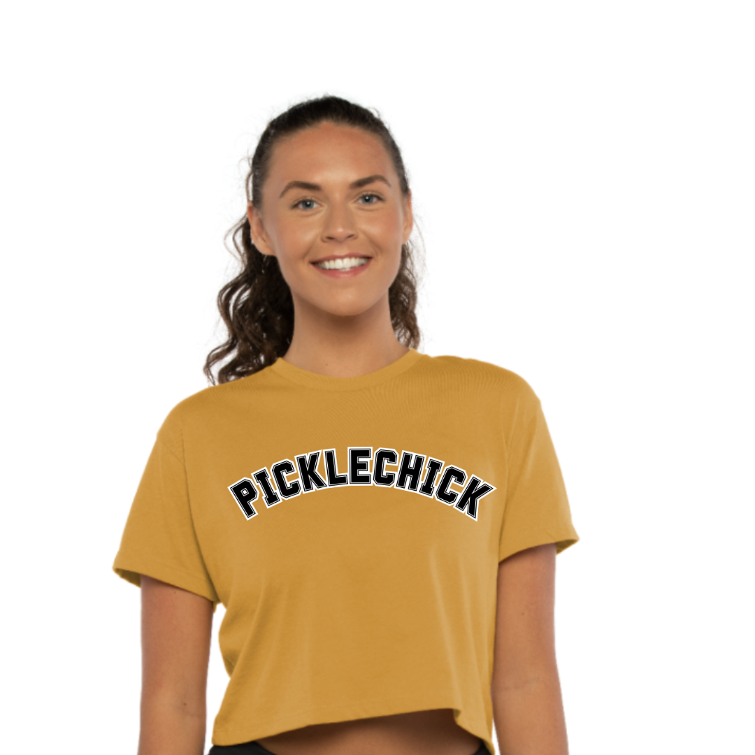 Introducing our exclusive PICKLECHICK cropped tee! Embrace the PickleChicks spirit and spread joy wherever you go when you wear it! Whether you’re dominating the court or simply enjoying life off the sidelines, wear your PICKLECHICK swag proudly and let your enthusiasm shine. Join the PickleChicks community today and be part of the pickleball movement that celebrates camaraderie, laughter, and the thrill of the game!