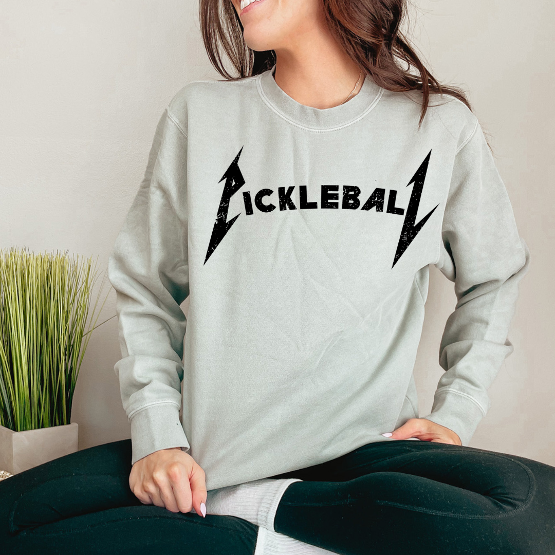Rock the court with this super soft pigment dyed sweatshirt , styled in the iconic font of a legendary rock band. It's a fusion of music and sport that's bound to turn heads on and off the court. Get ready to unleash your inner pickleball rockstar! 