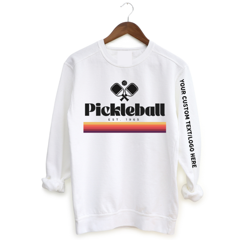 Experience the retro vibes and timeless comfort of our 1965 Pickleball Women's Sweatshirt. Step back in time and pay tribute to pickleball's origins with this fun, old-school, vintage collection that blends classic charm with modern style. Feel the premium softness of the fabric on your skin, and express your timeless style on and off the court. You will love how this fits! CUSTOMIZE WITH YOUR BRAND, LOGO OR PERSONALIZED TEXT 