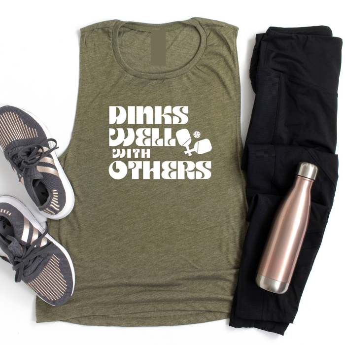 Indulge in the art of the dink with our Dinks Well With Others Tank! This one radiates playful charm and unmatched comfort, making it your go-to on and off the courts. Showcase your love for pickleball and your witty side in this statement piece that's sure to spark conversations and turn heads. Dink well, and do it in style in this tank top!! 
