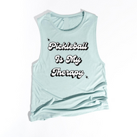Introducing the latest gem in the PickleChicks apparel line: the "Pickleball Is My Therapy" Tank Top. This isn't just any tank top; it's a statement, a testament to the transformative power of pickleball in our lives.