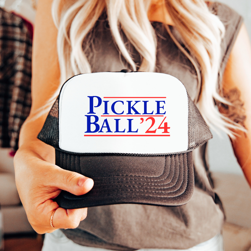 Introducing our exclusive “PickleBall ‘24”Trucker Hat – because who says politics can’t be a dill-lightful game?  Embrace the ultimate combo of PickleBall ‘24 and the upcoming 2024 Election!! Wear it proudly and let everyone know you’re on #TeamPickle. PickleBall ‘24 is the pickle-fied fashion statement that’s both baller and bipartisan! 