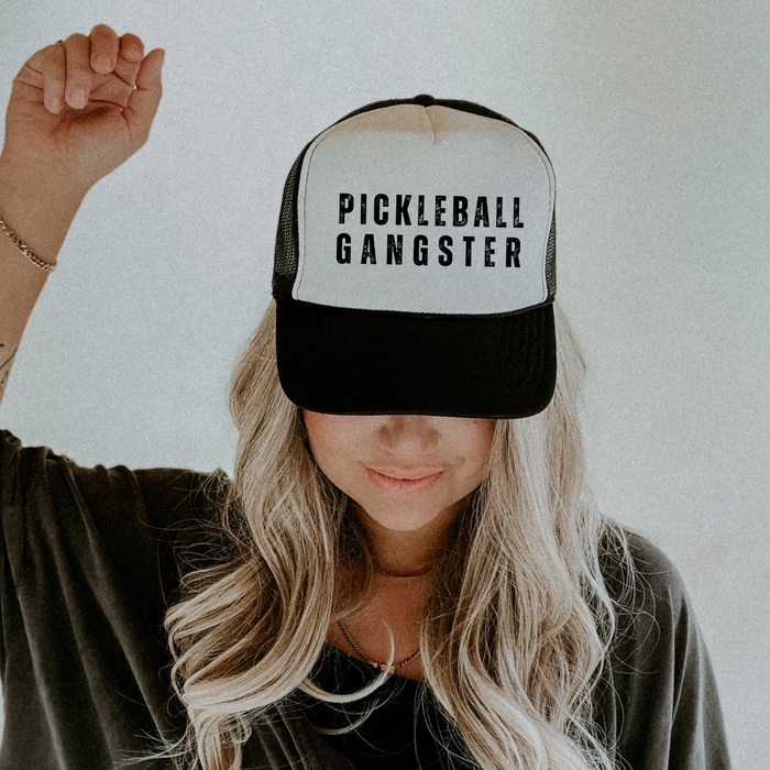 Unleash your inner pickleball boss with our Pickleball Gangster Trucker Hat! It's more than just a hat, it's a statement. Whether you're dominating on the court or off, this hat will show just how passionate and unstoppable you are. Wear on and off the courts! Either way you'll look amazing and love how you feel! Join the pickleball gang today and let this hat speak for itself!