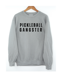 Unleash your inner pickleball boss with our Pickleball Gangster Sweatshirt! It's more than just a sweatshirt, it's a statement. Whether you're dominating on the court or off, this sweatshirt will show just how passionate and unstoppable you are. Wear with leggings, a skort/skirt, shorts or jeans. Either way you'll look amazing and love how you feel! Join the pickleball gang today and let this sweatshirt speak for itself!