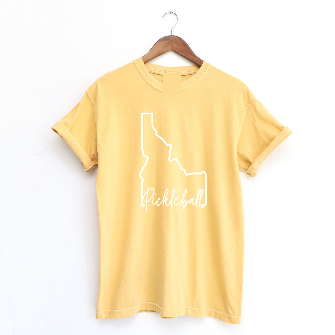 Elevate your style and showcase your love for both the Gem State and pickleball with our Pigment Dyed Idaho Pickleball t-shirt!  Crafted with care, this tee is more than just an article of clothing; it's a statement of pride and passion. 
