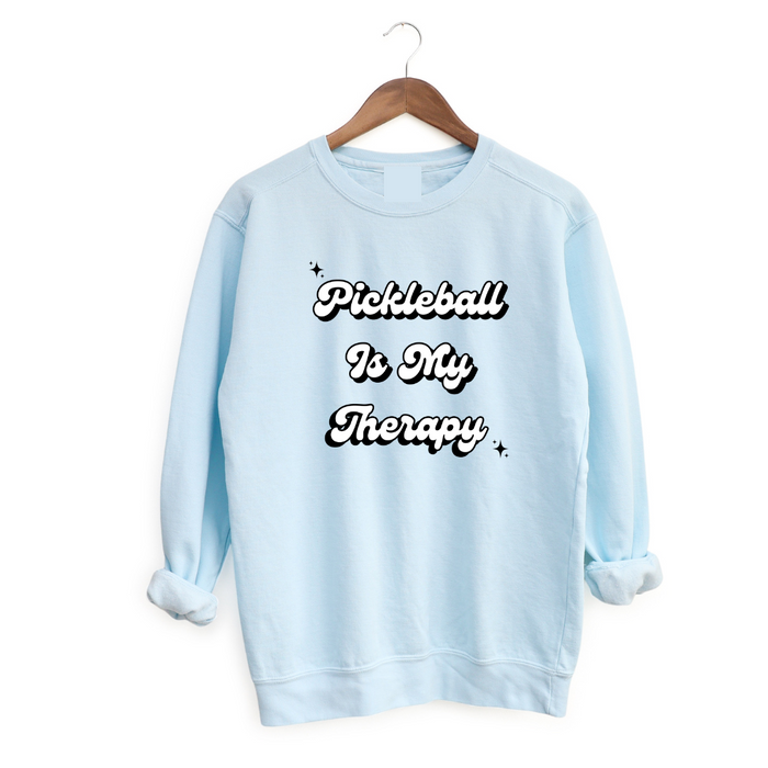 Introducing the latest gem in the PickleChicks apparel line: the "Pickleball Is My Therapy" Sweatshirt. This isn't just any sweatshirt, it's a statement, a testament to the transformative power of pickleball in our lives.