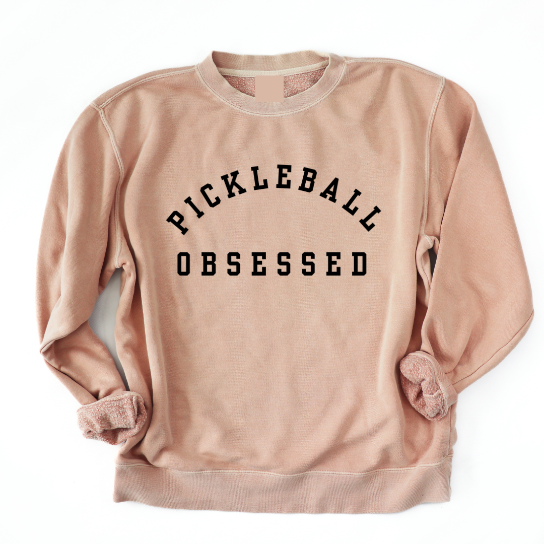 Show your pickleball passion with our Pickleball Obsessed Sweatshirt! Crafted with impeccable quality and offered in a variety of pigment dyed colors.  You'll love how this sweatshirt works for dominating the courts or adding a dash of pickleball flair to your everyday style.