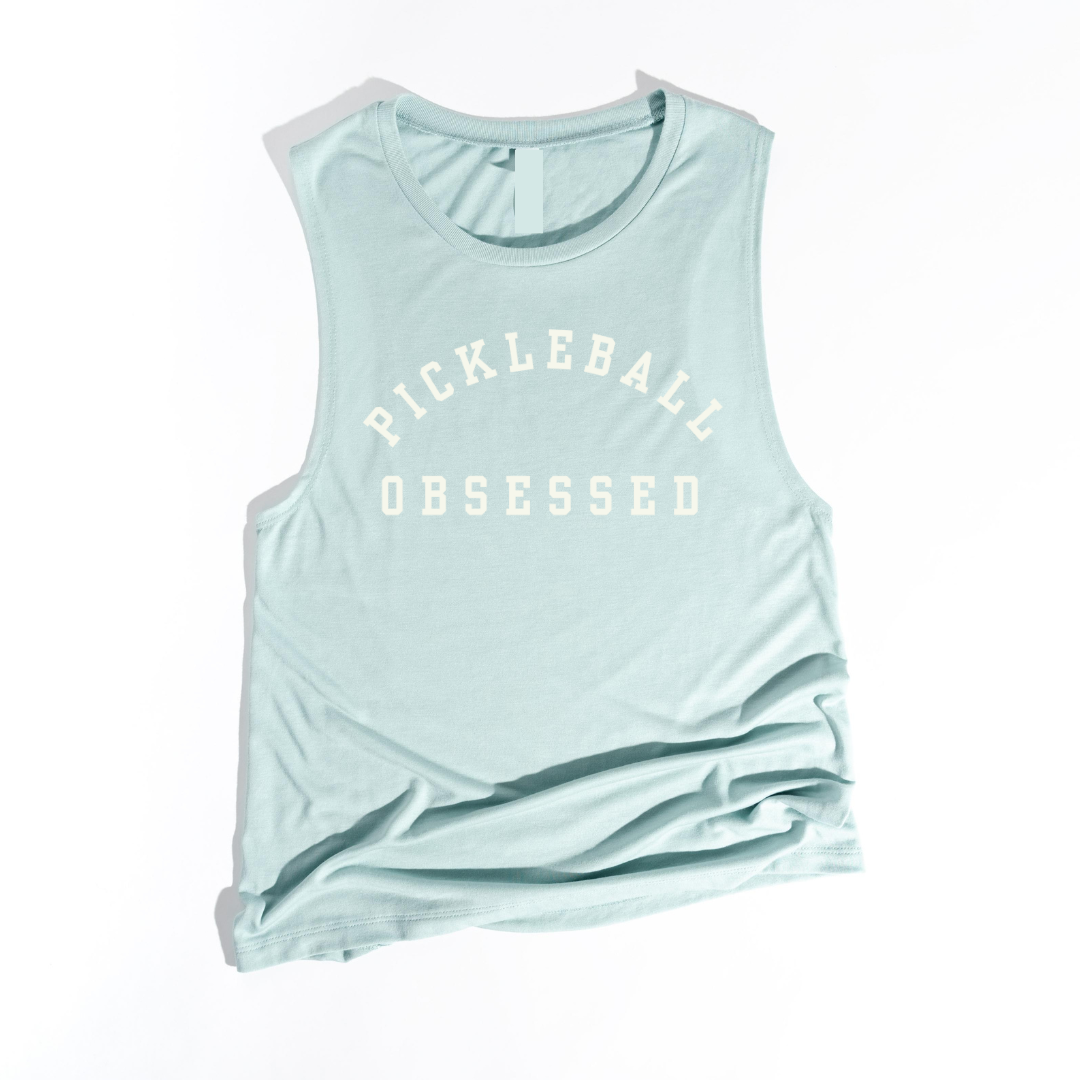 Show your pickleball passion with our Pickleball Obsessed tank top! Crafted with impeccable quality and offered in a variety of colors.  You'll love how this tank works for dominating the courts or adding a dash of pickleball flair to your everyday style. Wear alone of layer with your favorite jacket! Get ready for your new favorite tank- one that screams obsession, comfort, and unmistakable pickleball pride!