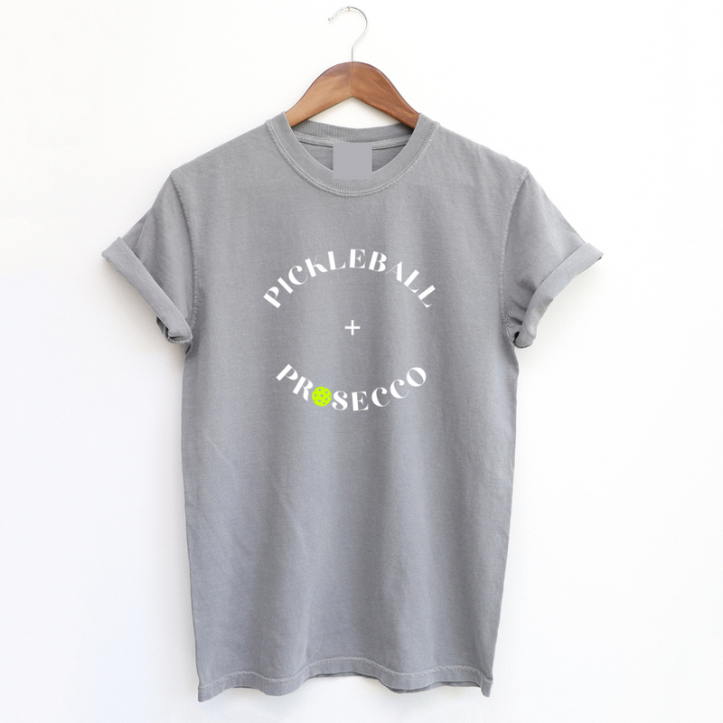 Introducing our Pickleball + Prosecco Tee, where sport meets sophistication! Crafted for comfort and style these tees are top quality as well as the perfect blend of cozy warmth, comfort and playful elegance. 