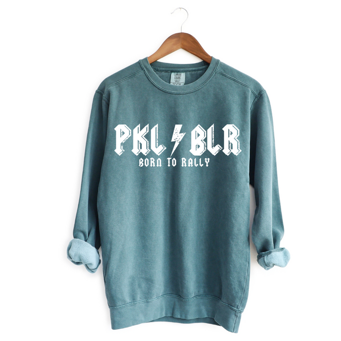 Introducing our PKLBLR Born To Rally Sweatshirt. Crafted with premium quality, it offers a range of great colors to match your style. Whether you're on the courts or out and about, it's the perfect choice to proudly represent yourself as a PKLBLR - a dedicated pickleballer who loves everything the game has to offer. Let's GO ballers! 
