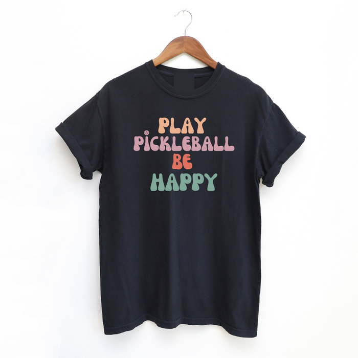Introducing our Play Pickleball Be Happy tee- the perfect addition to your pickleball wardrobe! It's all super cute while telling the undeniable truth- that playing pickleball brings joy and happiness to your day.