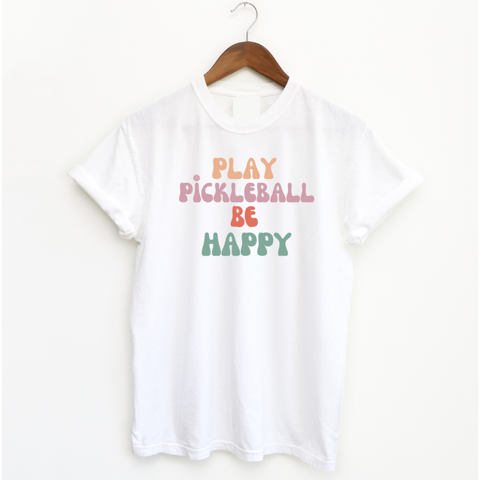 Introducing our Play Pickleball Be Happy tee- the perfect addition to your pickleball wardrobe! It's all super cute while telling the undeniable truth- that playing pickleball brings joy and happiness to your day.